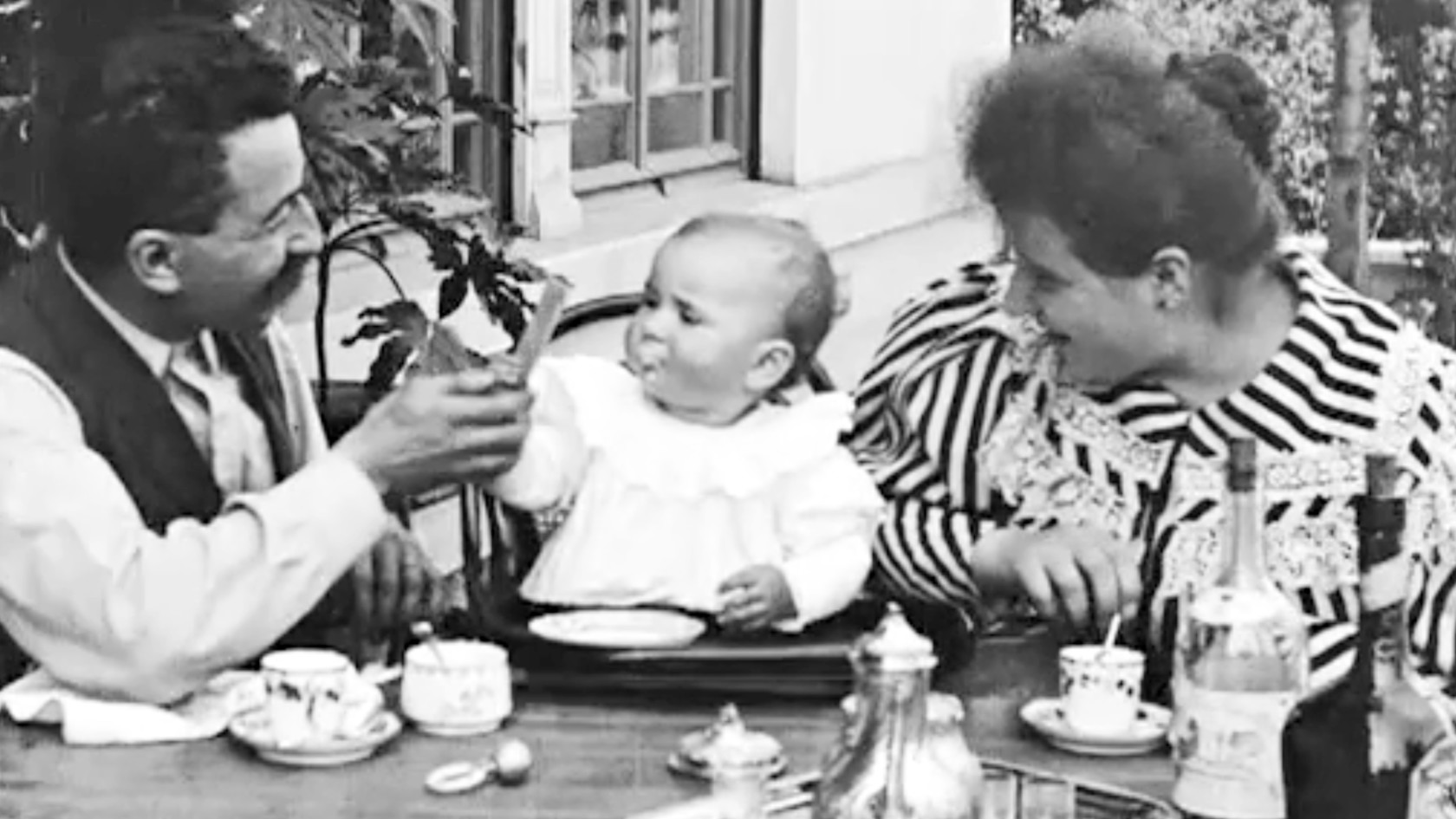 black and white image of parent feeding their toddler, screenshot from the film "repas de bébé from 1895