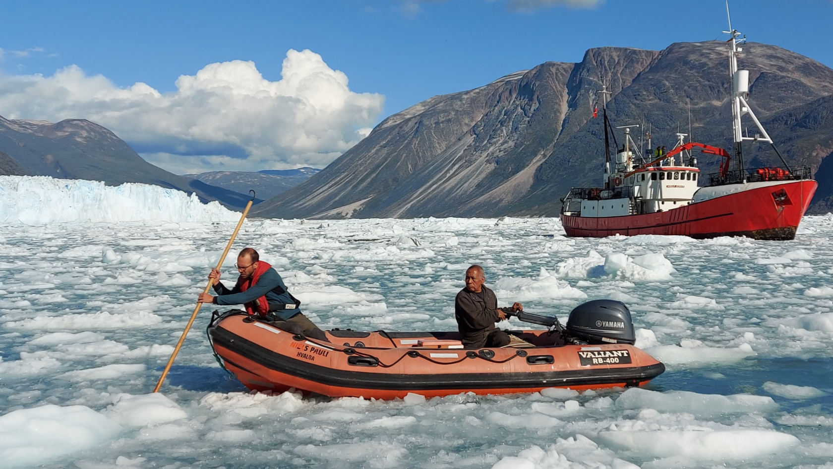 Researcher Dominik Gräff (left) and a crew member on their way to shore in a Zodiac boat.