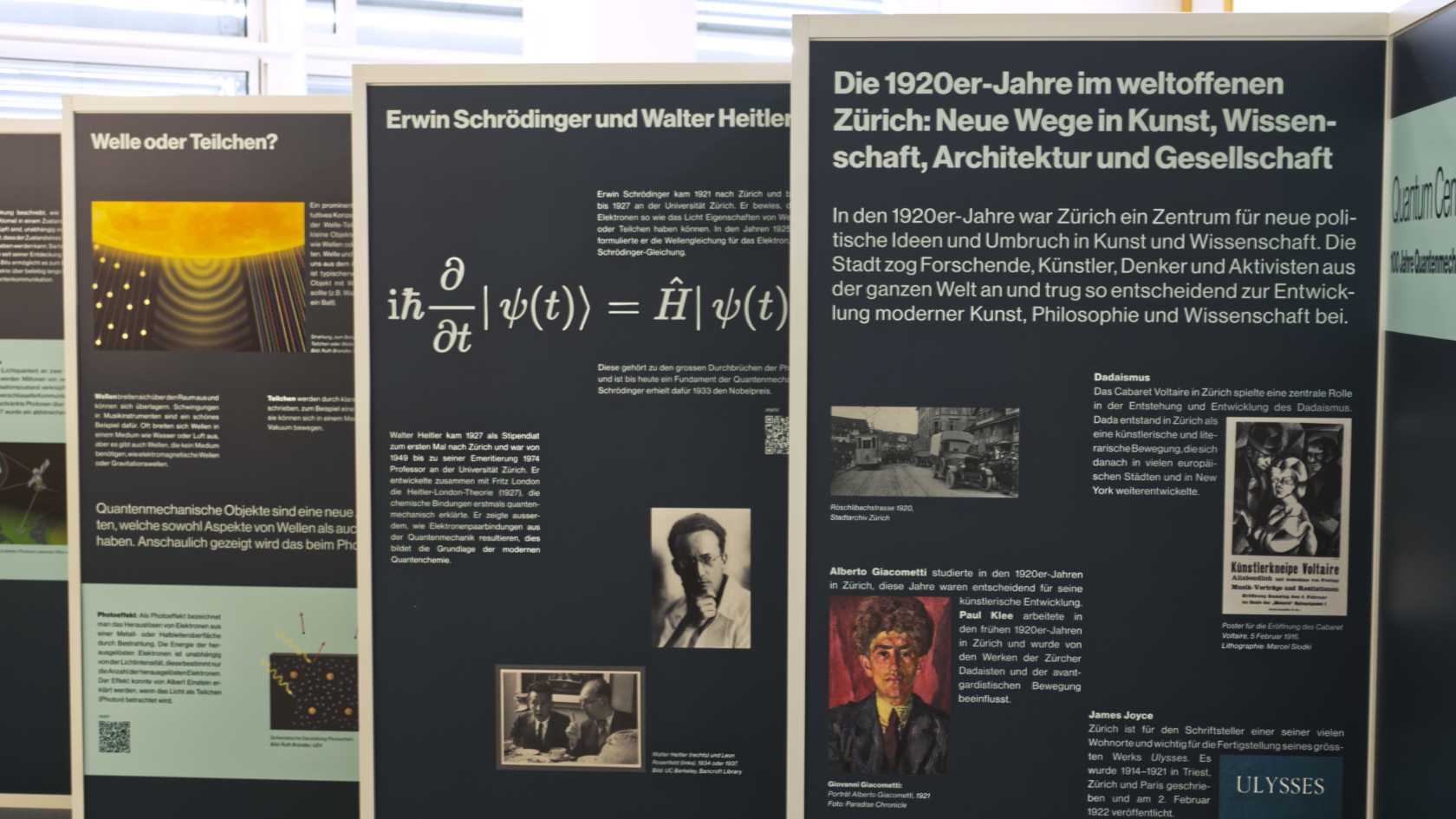 Several exhibition panels with information and images on the history of quantum mechanics.